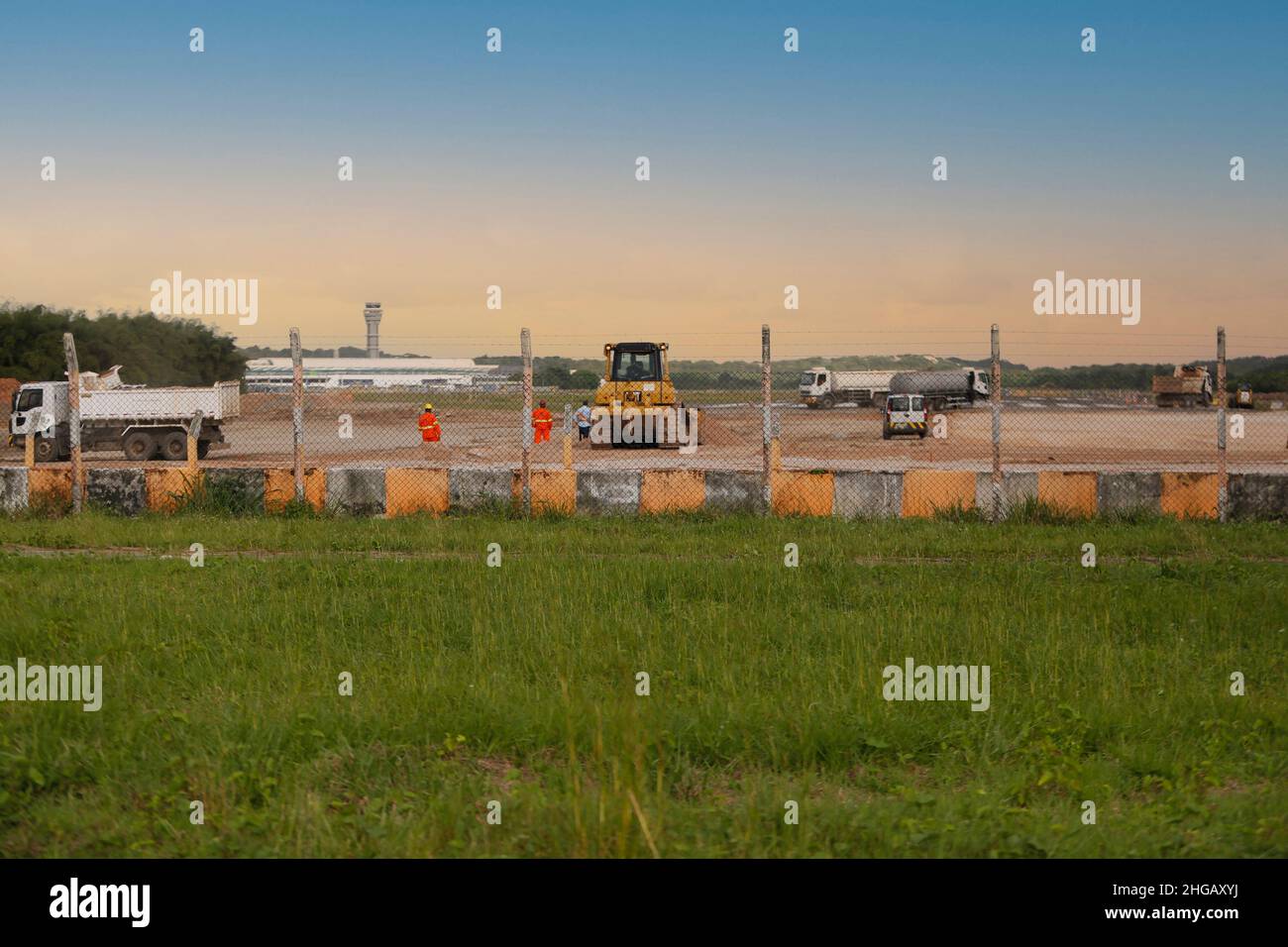 salvador, bahia, brazil - june 14, 2018: Workers and machines are seen during renovation work on the runway at the airport in the city of Salvador. Stock Photo