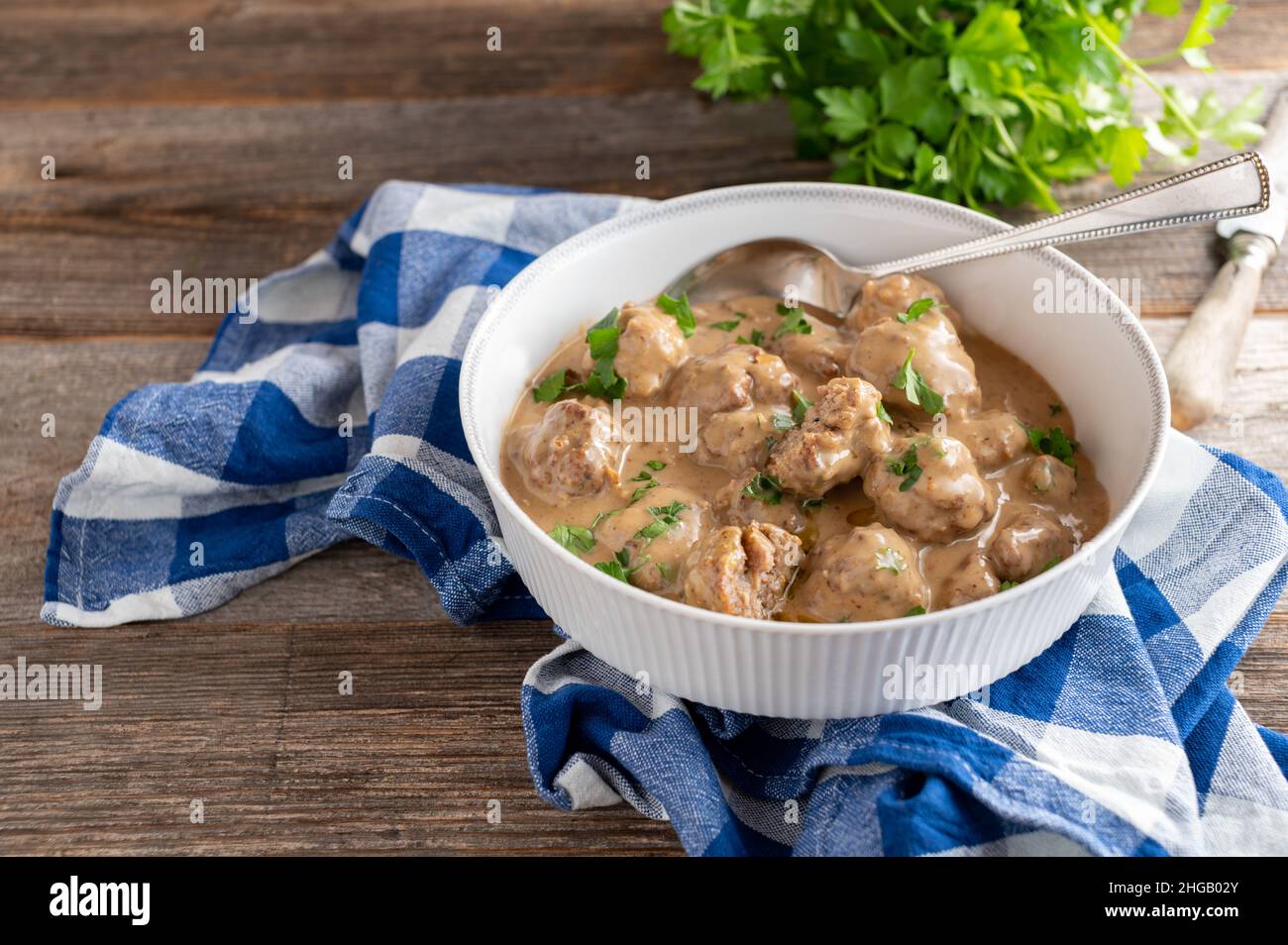 Traditional homemade cooked köttbullar, swedish meatballs in a delicious cream sauce. Stock Photo