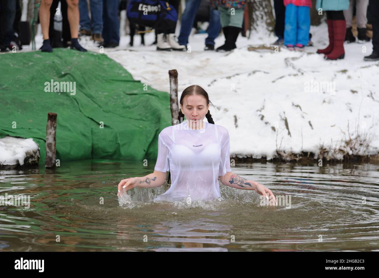 People of orthodox religion bathe in cold water during the celebration of Epiphany. People believe that water has special healing properties and can be used to treat various diseases, and many of them take ice baths as part of its celebration. Stock Photo