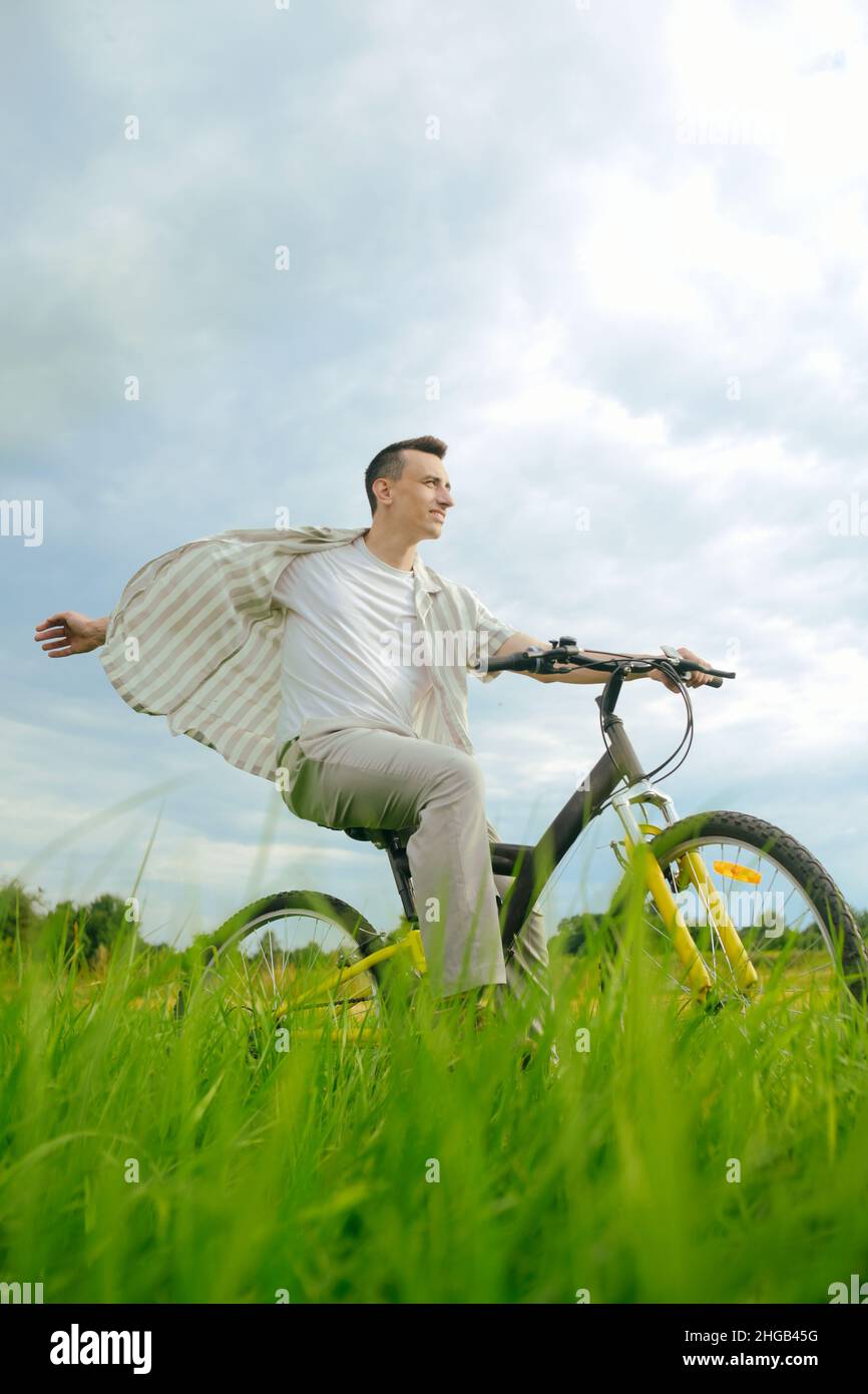 The man is riding a mountain bike. A fashionable guy came to nature in ...