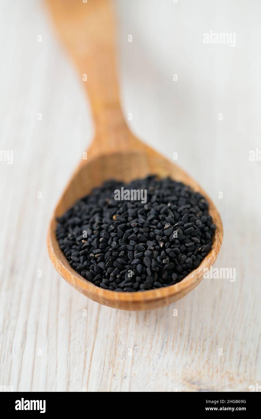 black cumin on wooden surface Stock Photo