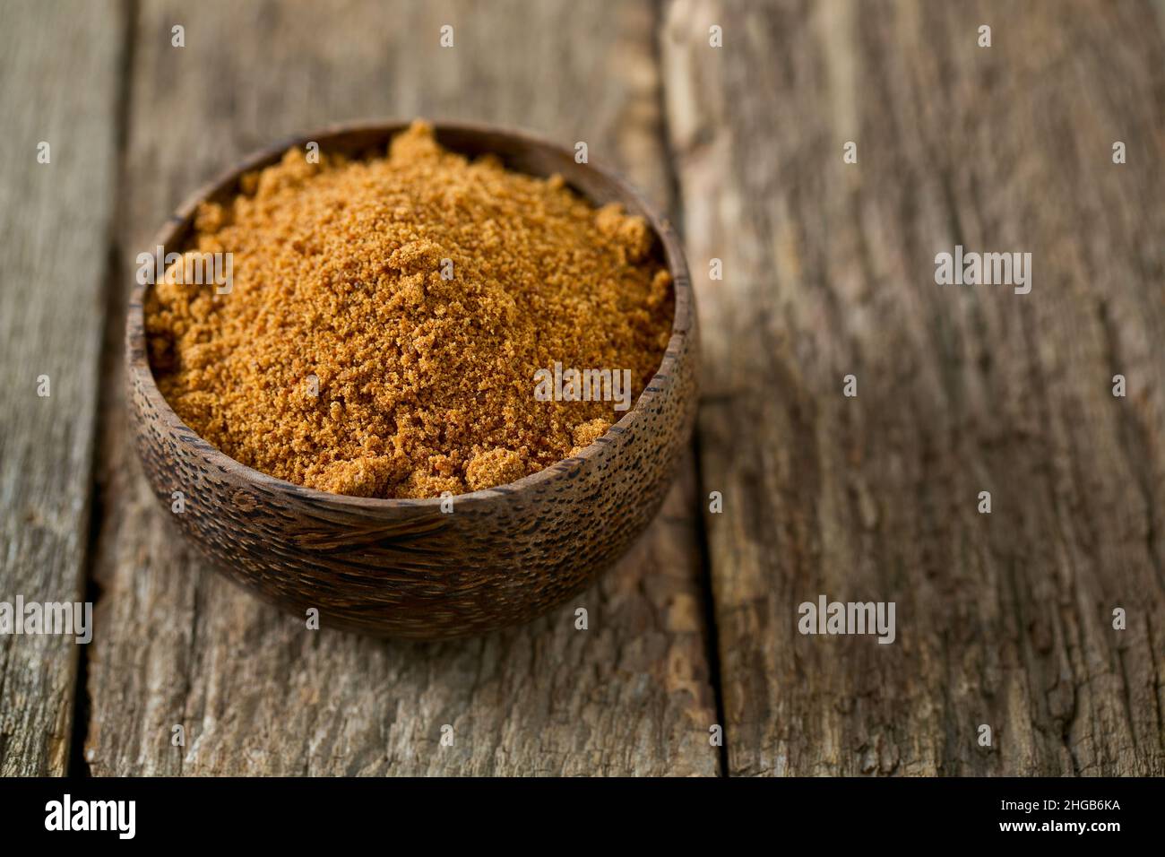 coconut palm sugar on wooden surface Stock Photo