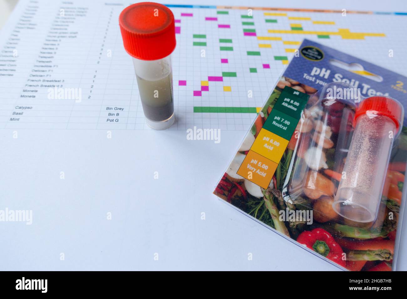 Soil PH test kit alongside a gardening planning calendar Stock Photo