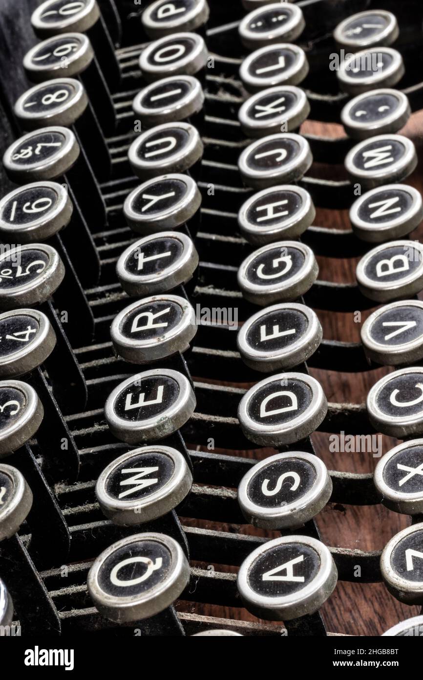 Antique typewriter showing traditional QWERTY keys. Before text messaging, people used typewriters to communicate by writing letters. Stock Photo