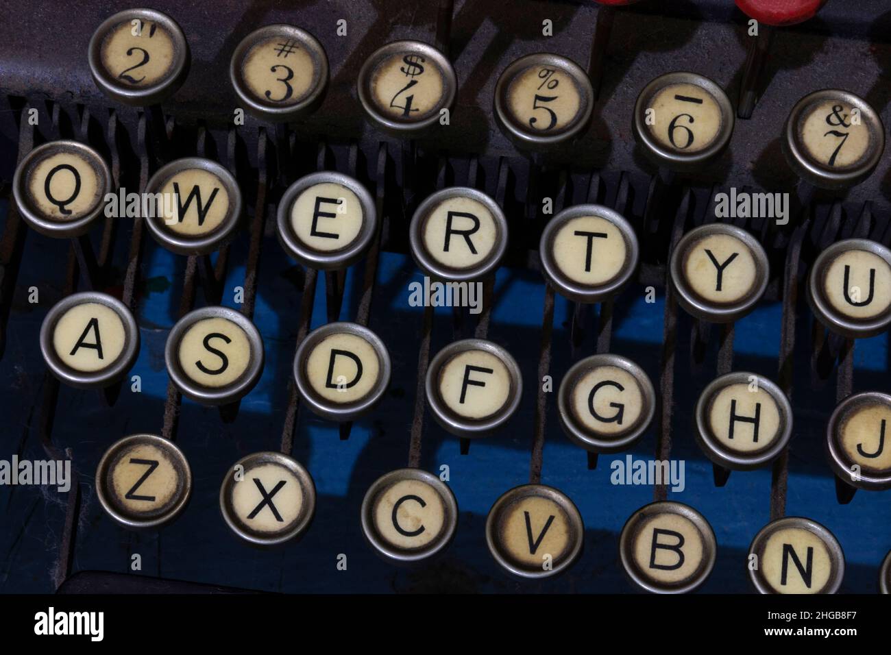 Antique typewriter showing traditional QWERTY keys. Before text messaging, people used typewriters to communicate by writing letters. Stock Photo