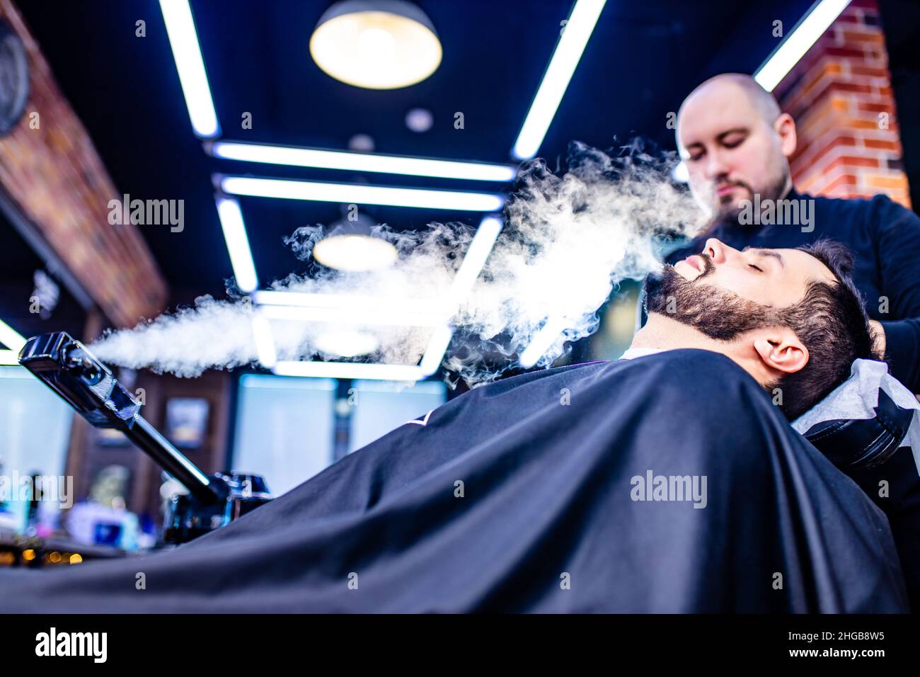 arabic handsome bearded man getting condensation moisture haircut at  barbershop Stock Photo - Alamy