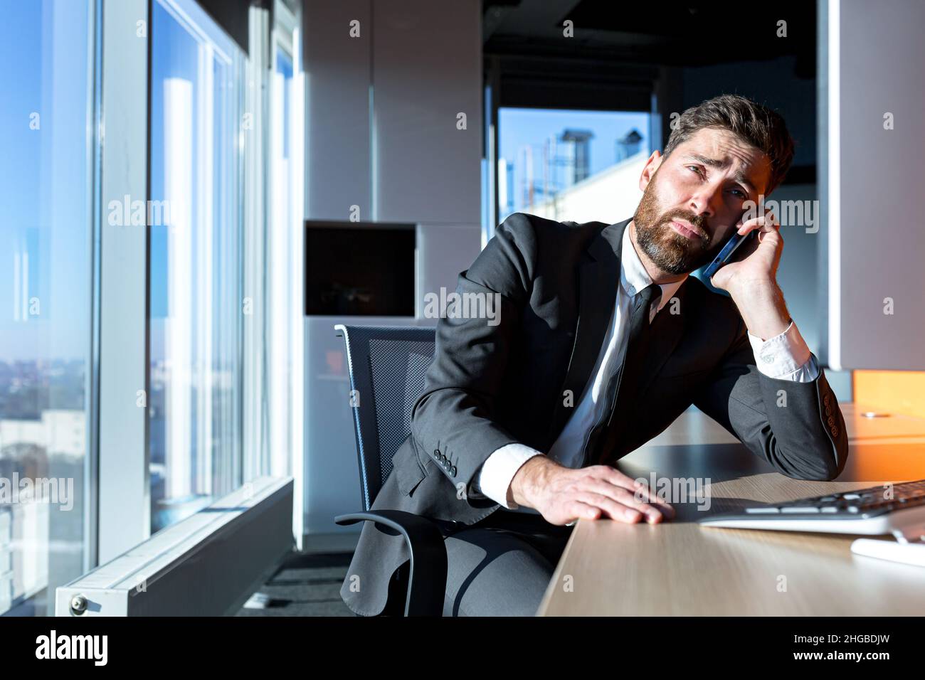 bored businessman works in the office, at the computer, falls asleep ...