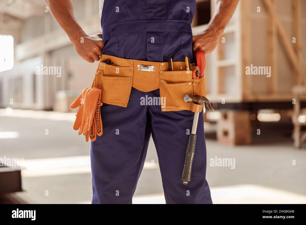 Male builder wearing tool belt with instruments Stock Photo Alamy