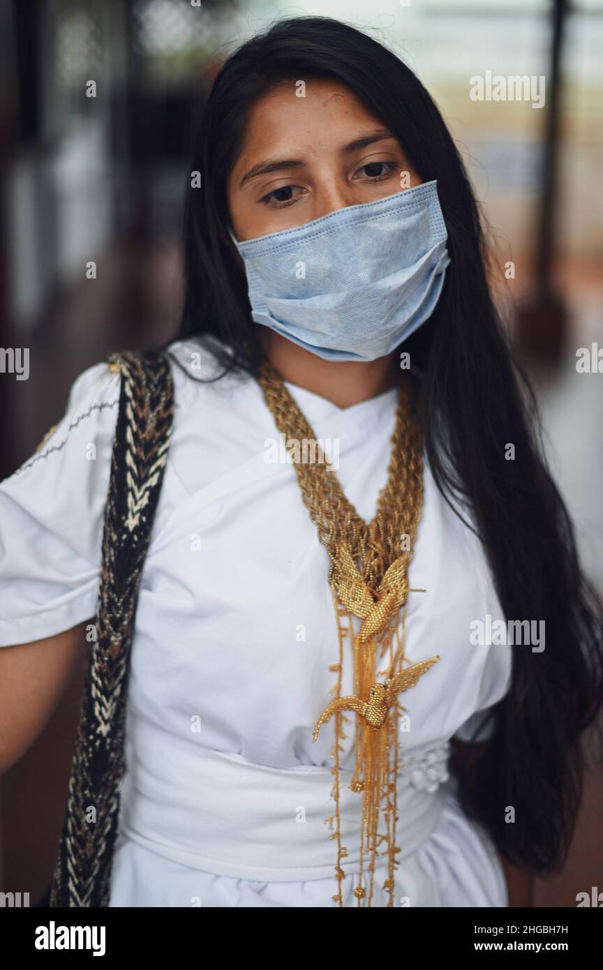 Portrait of contemplative young Arhuaco indigenous woman wearing a face mask during the Covid-19 outbreak in Colombia Stock Photo
