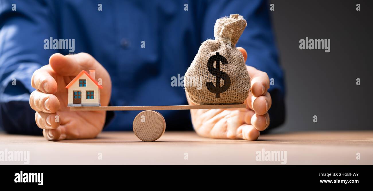 House Model Balance Equilibrium Concept. Real Estate Money Stock Photo