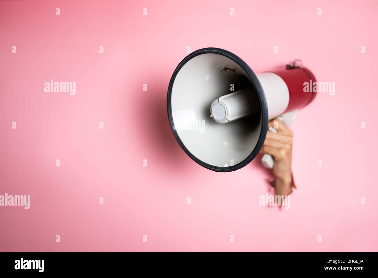 Hand From Broken Wall Hole Megaphone Announcement Stock Photo