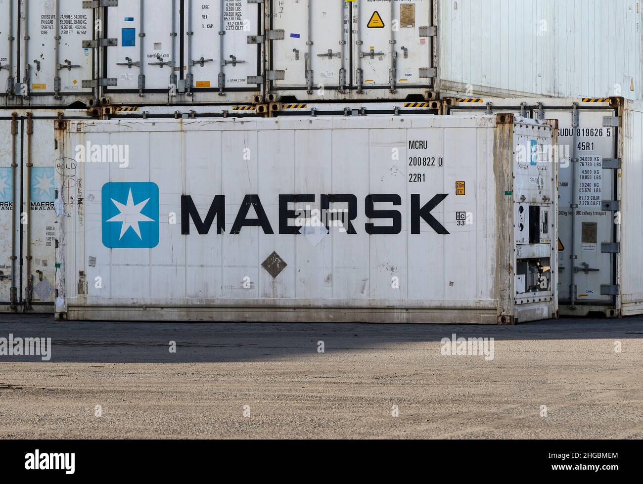 Maersk shipping containers with company logo signage. White refrigerated crates used to transport or ship chilled goods or freight. Ireland Stock Photo