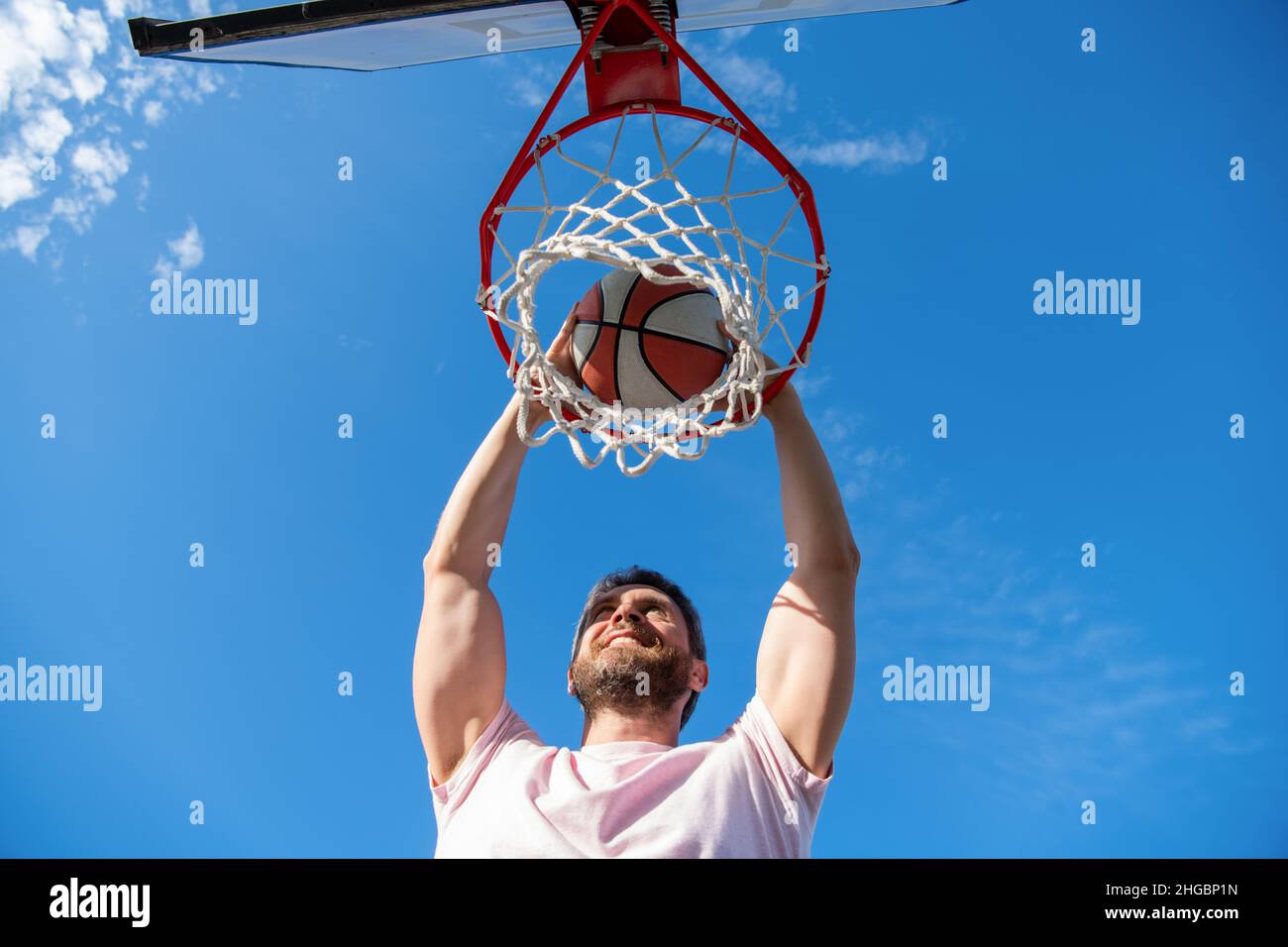 high view of basketball player throws the ball into the hoop outdoor, motivation Stock Photo Alamy