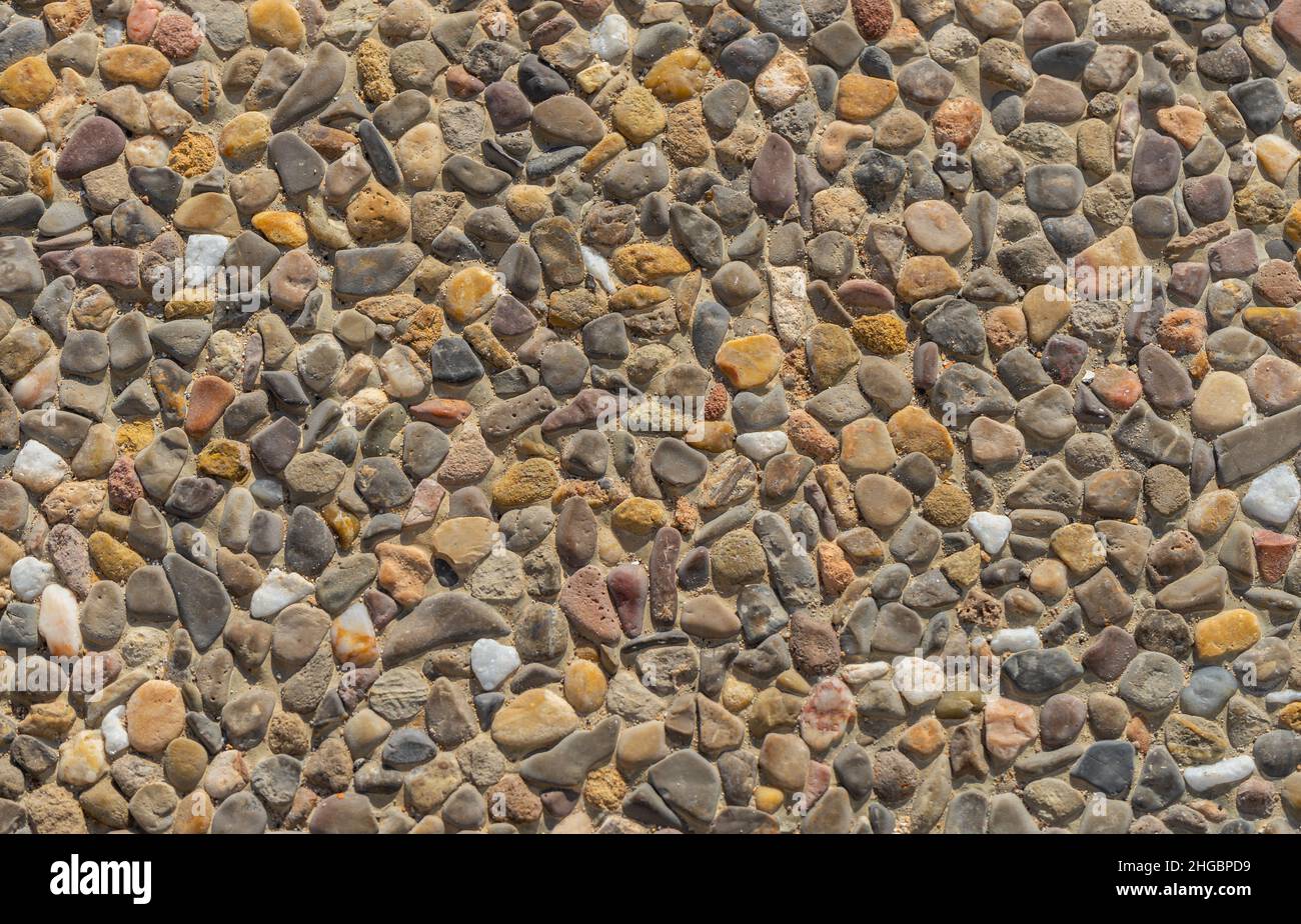 Floor made up of tiles with small stones embedded in them of different
