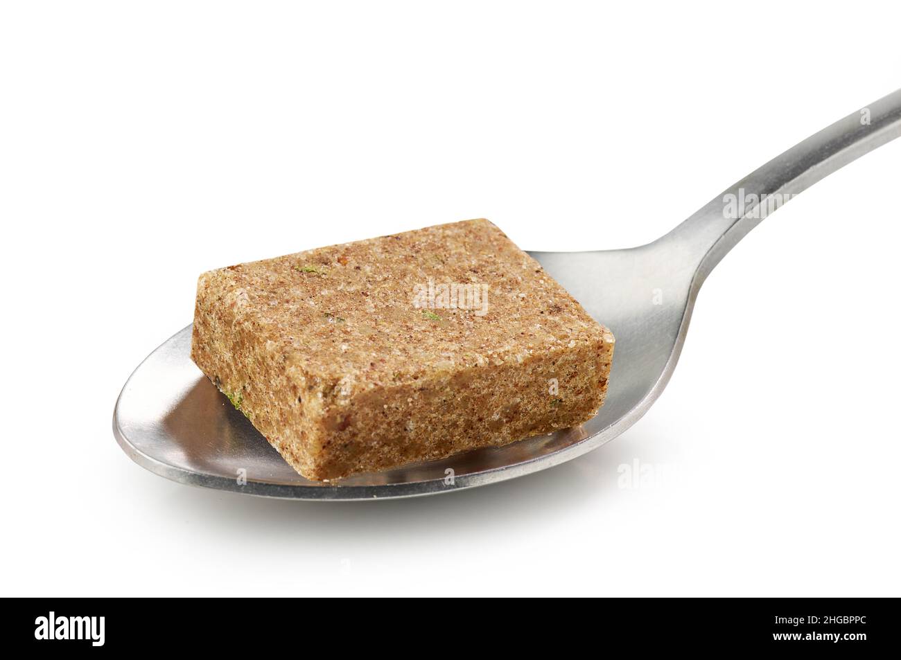 instant beef broth cube in a spoon isolated on white background Stock