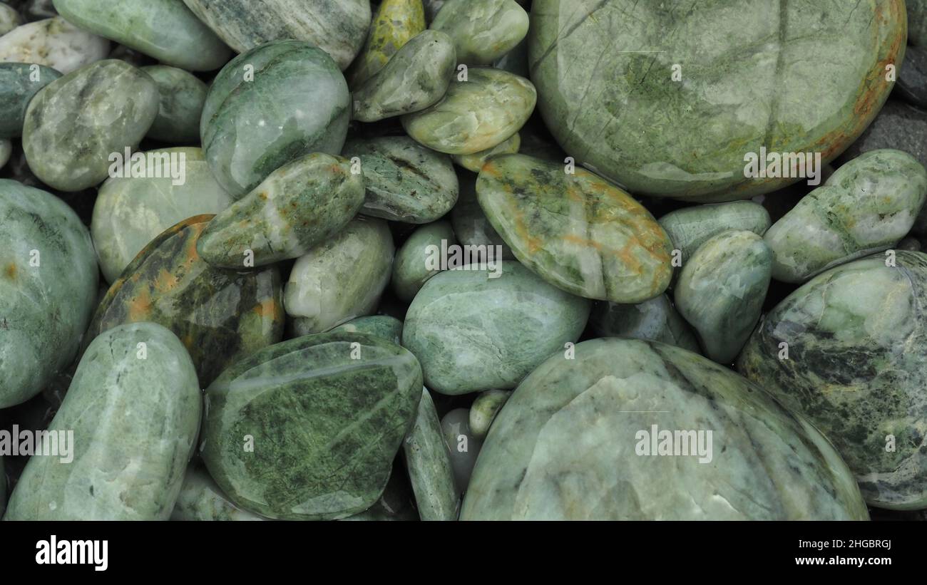 Round greenish beach stones on the West Coast, New Zealand Stock Photo