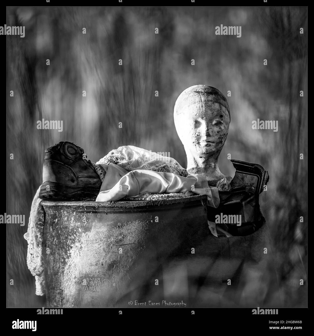 Creepy Ethereal Ghostly Possessed Trash Can Black and White found in an abandoned field. Stock Photo