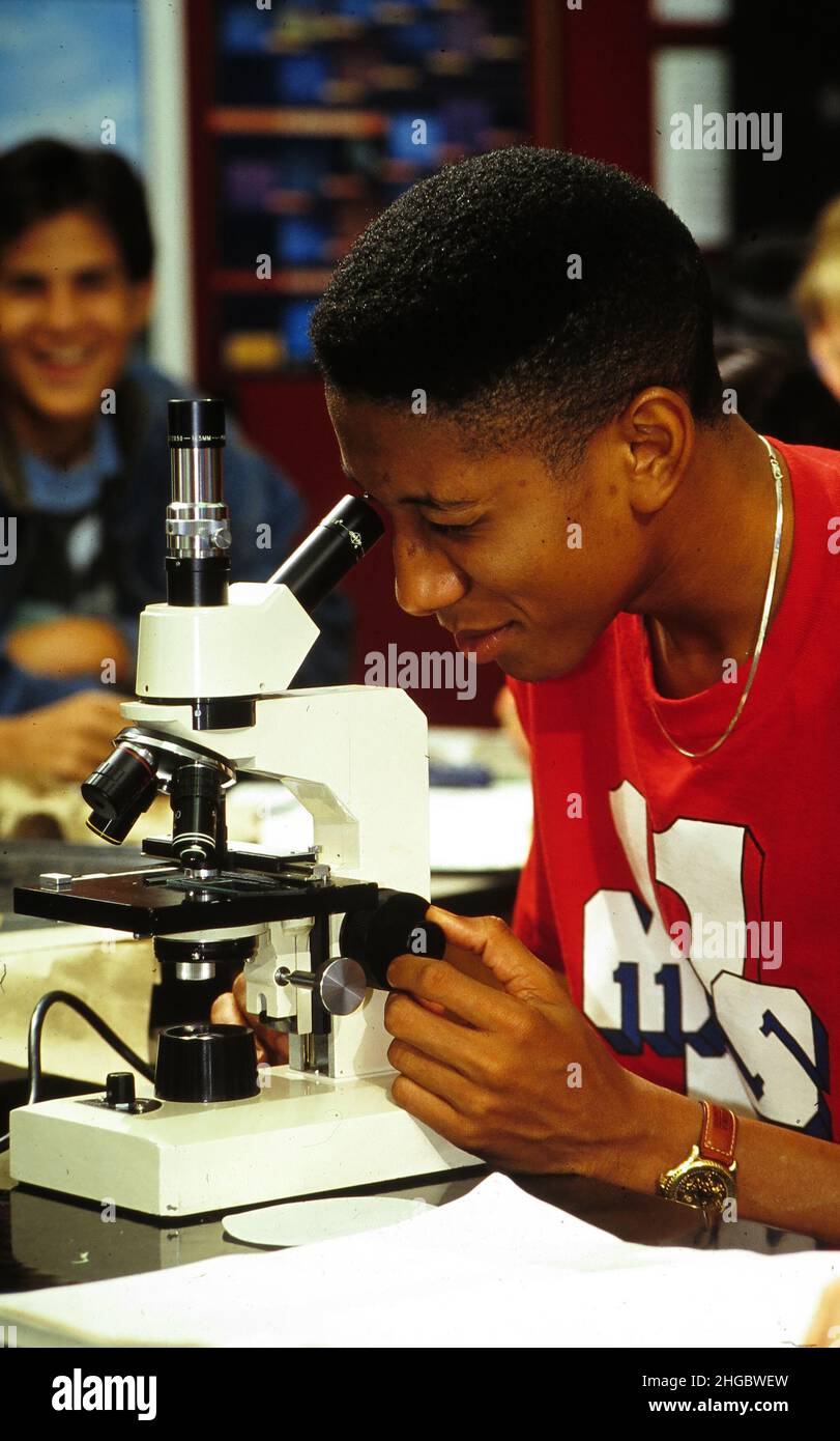 Austin, Texas USA 1994 Teen in high school biology class peers into
