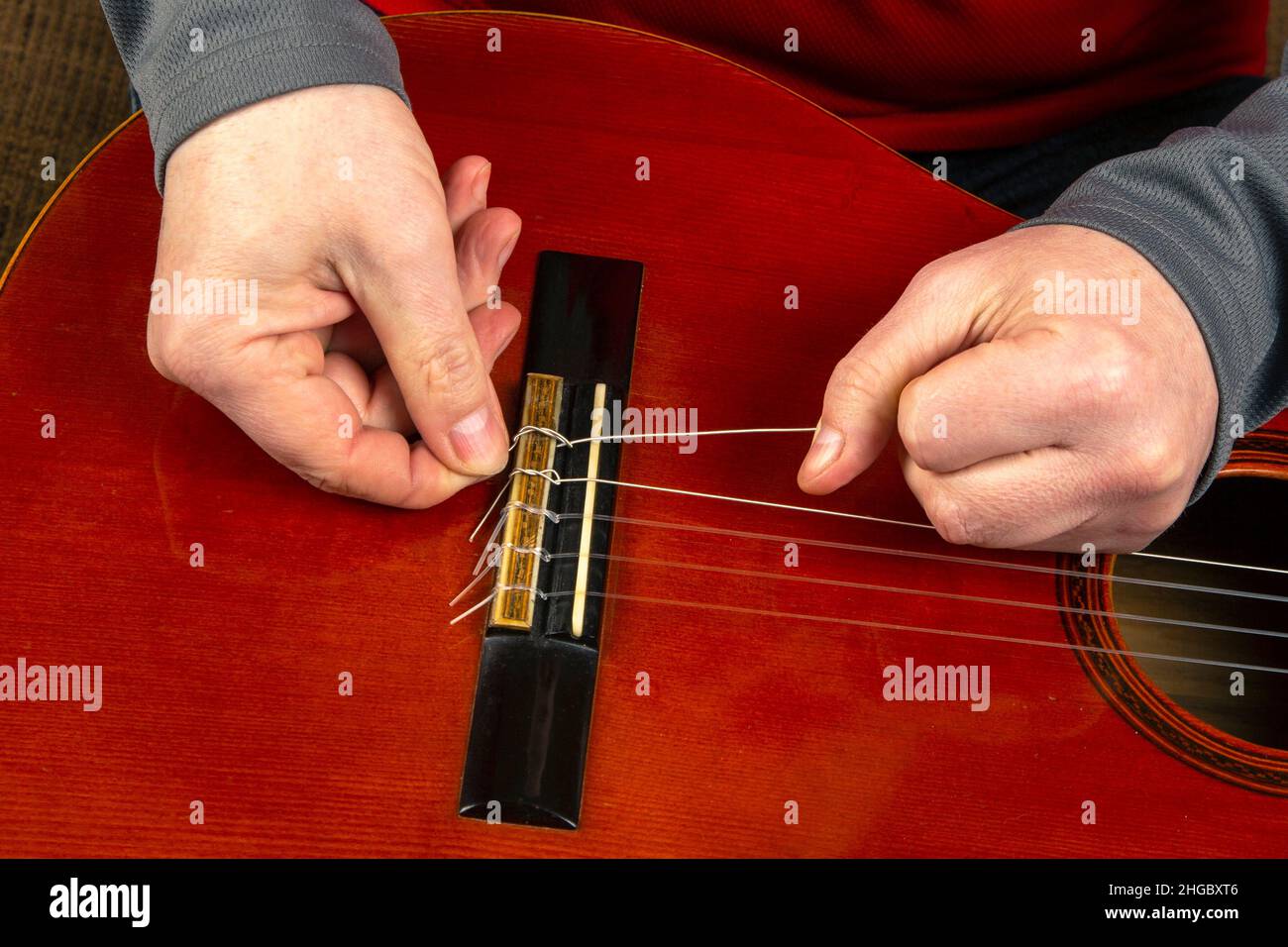 replacement and insertion of nylon strings in a classical guitar