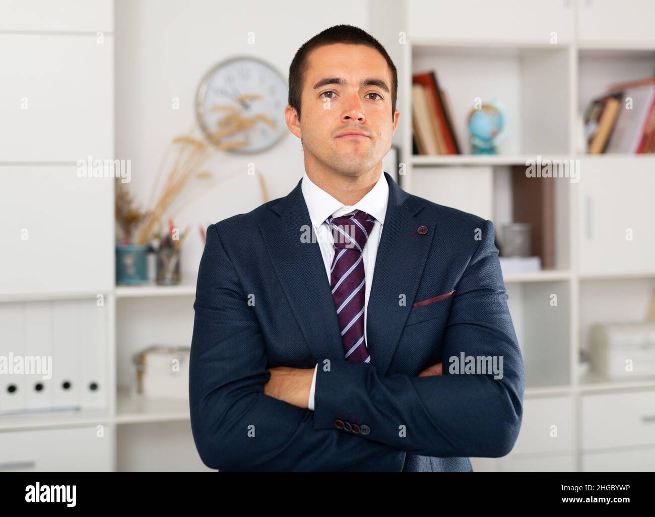 Successful businessman with arms crossed in office interior Stock Photo ...