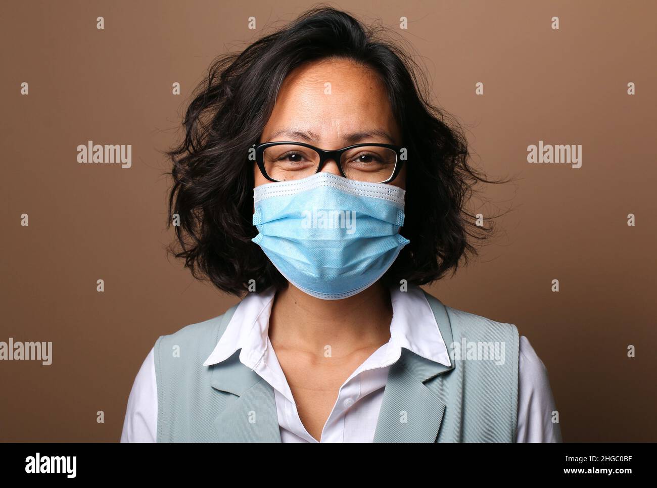 Beautiful woman wearing a mouth mask Stock Photo - Alamy