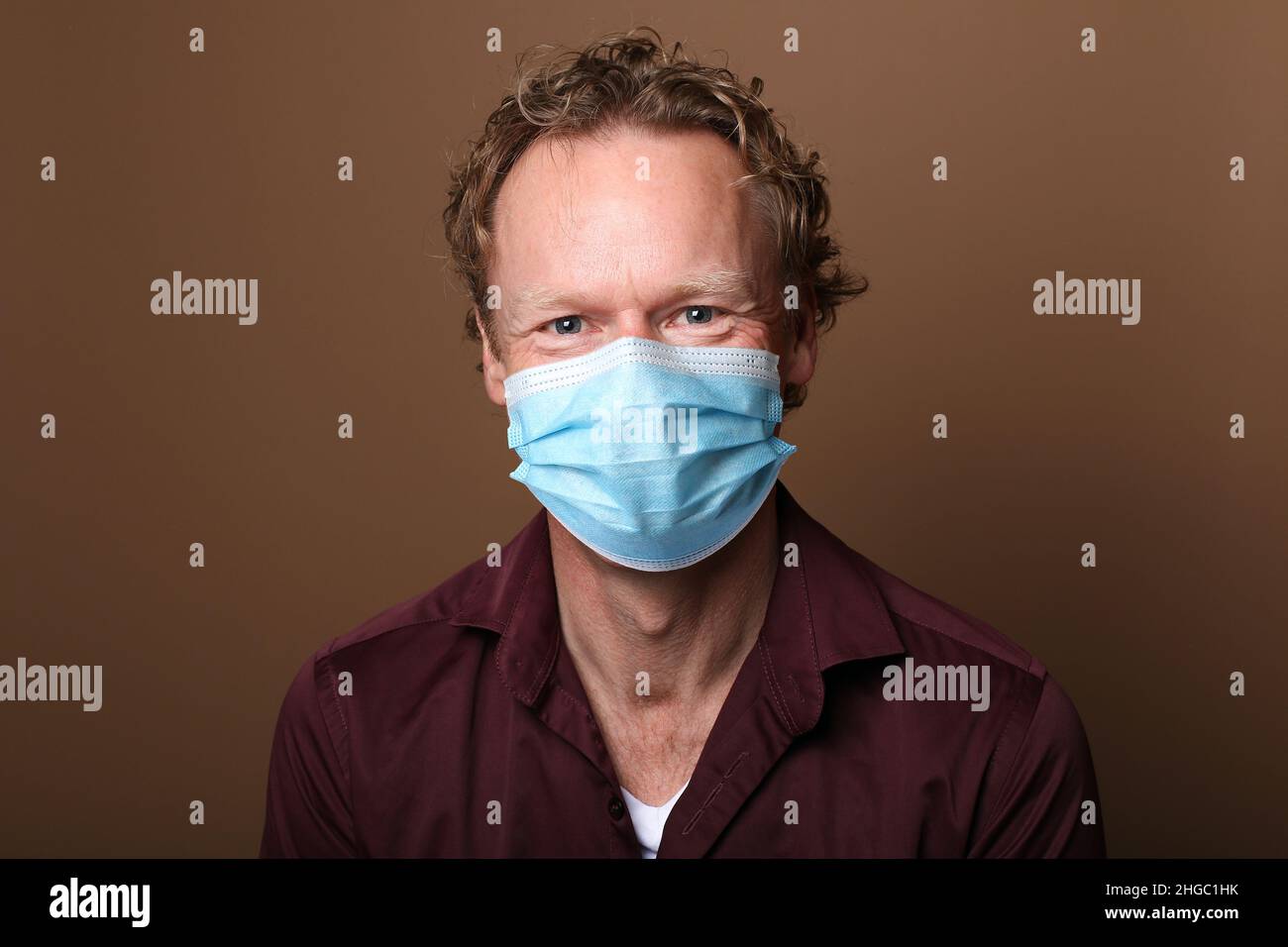 Beautiful man wearing a mouth mask Stock Photo - Alamy