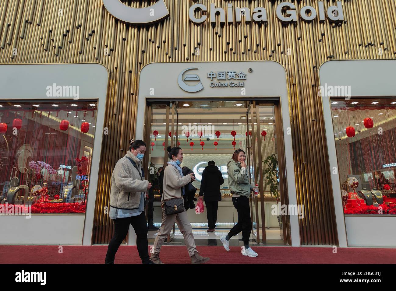 SHANGHAI, CHINA - JANUARY 19, 2022 - Customers choose and buy gold jewelry at a China Gold store in Shanghai, China, On January 19, 2022. Stock Photo
