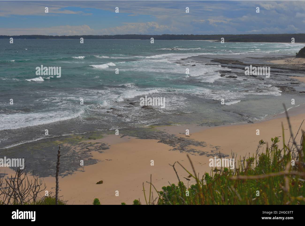 a view of a beach in Jervis Bay, NSW, Australia with surrounding beachfront houses and flora Stock Photo