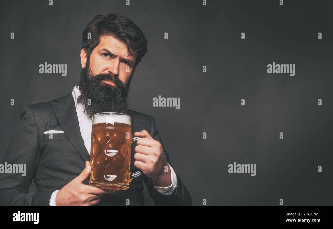 Beer pubs and bars. Enjoy in pub. Retro man in black suit with a beer. Retro advertising of alcoholic beverages. Stock Photo