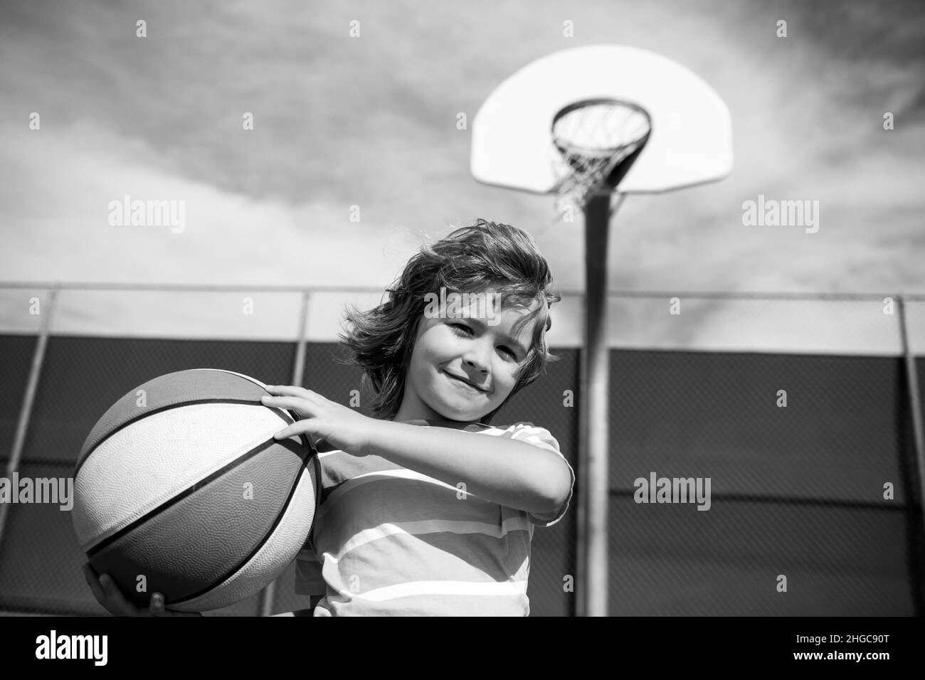 Little child boy playing basketball with basket ball Stock Photo