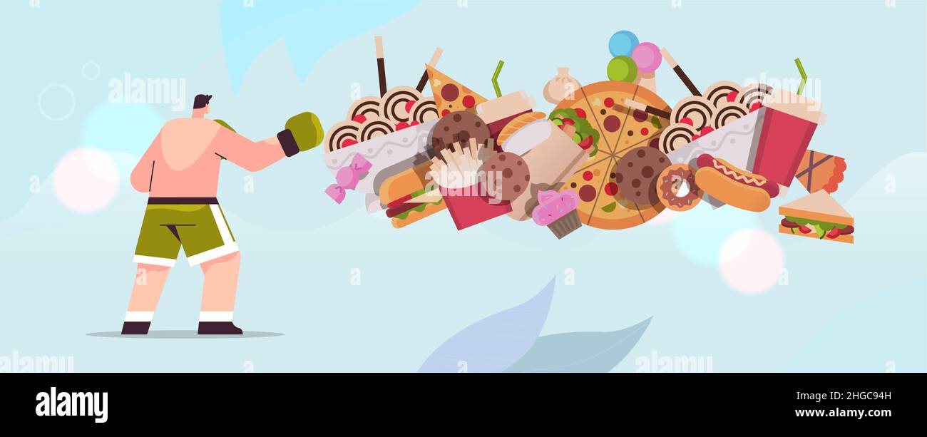 man boxer hitting junk food assortment of fast food unhealthy nutrition