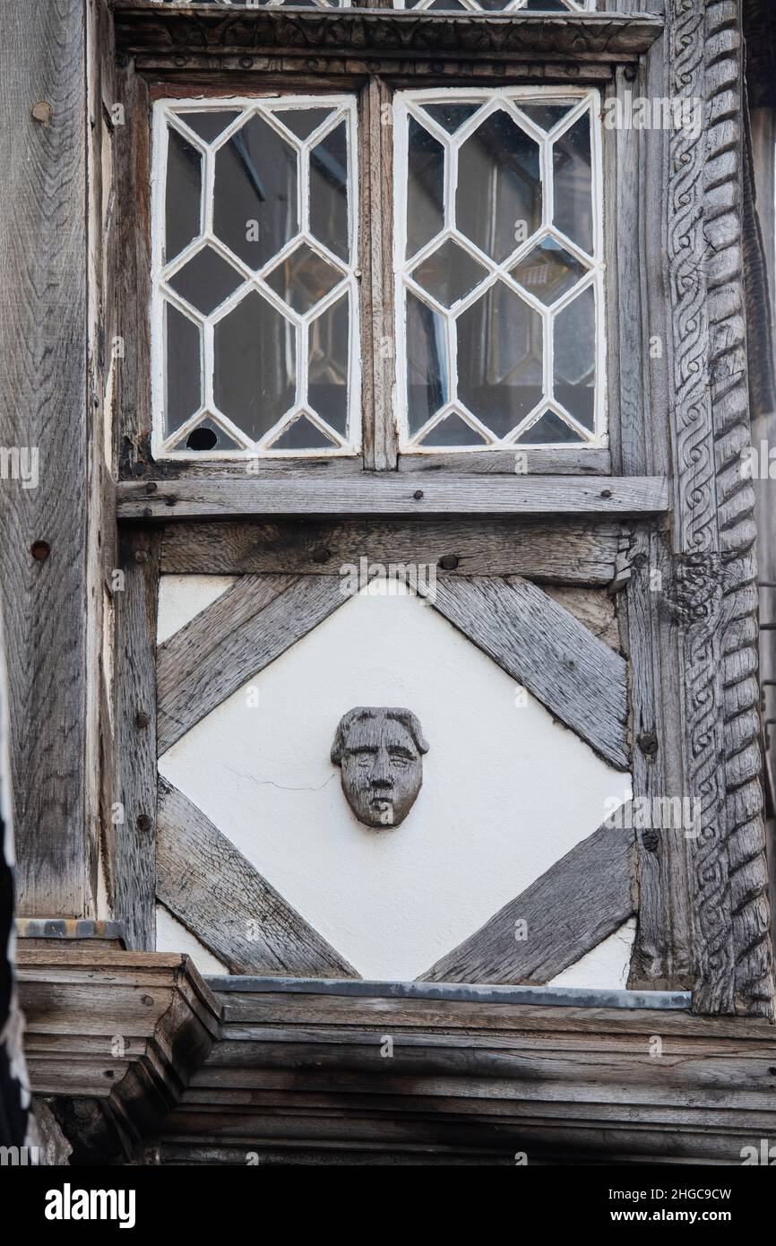 The Feathers hotel wooden face carving. 17th century timber framed period building. Ludlow, Shropshire, England Stock Photo