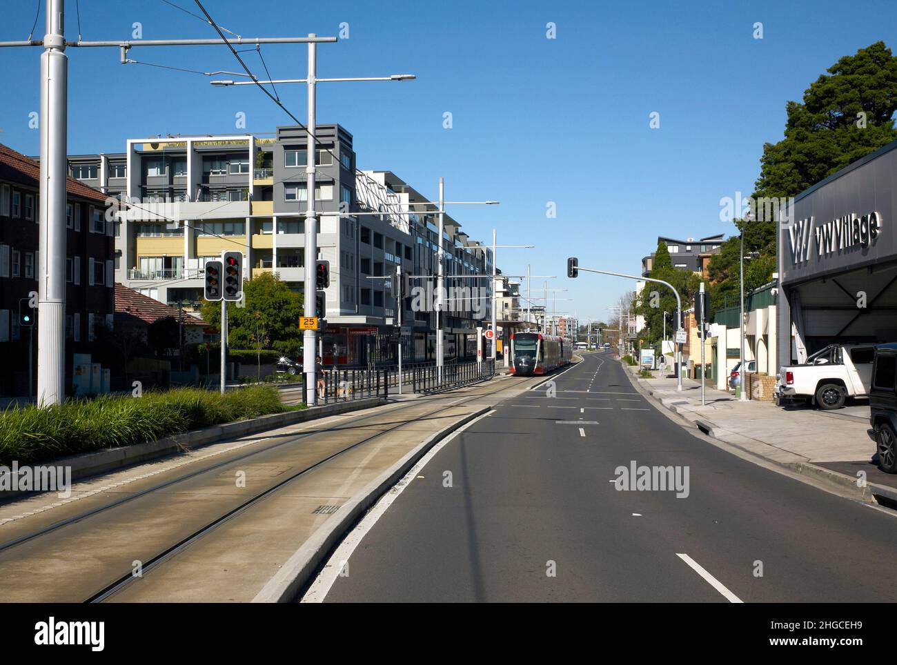 Colour photograph of apartments, commercial outlets and CBD and South East Light Rail, Anzac Parade, Kensington, Sydney, New South Wales, Australia Stock Photo