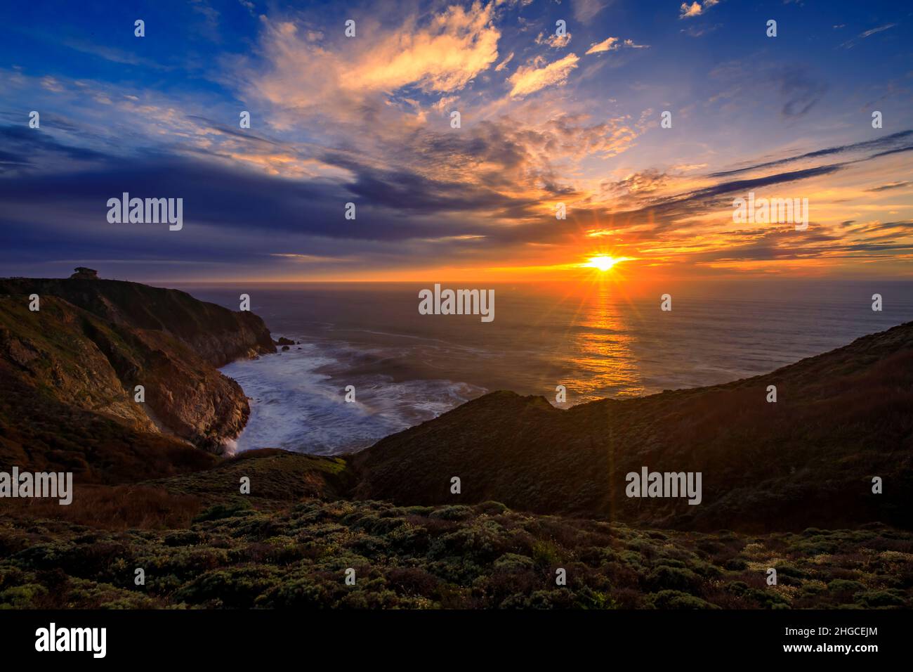 Rugged cliffs by Devil's Slide trail in California, with a sunburst at ...
