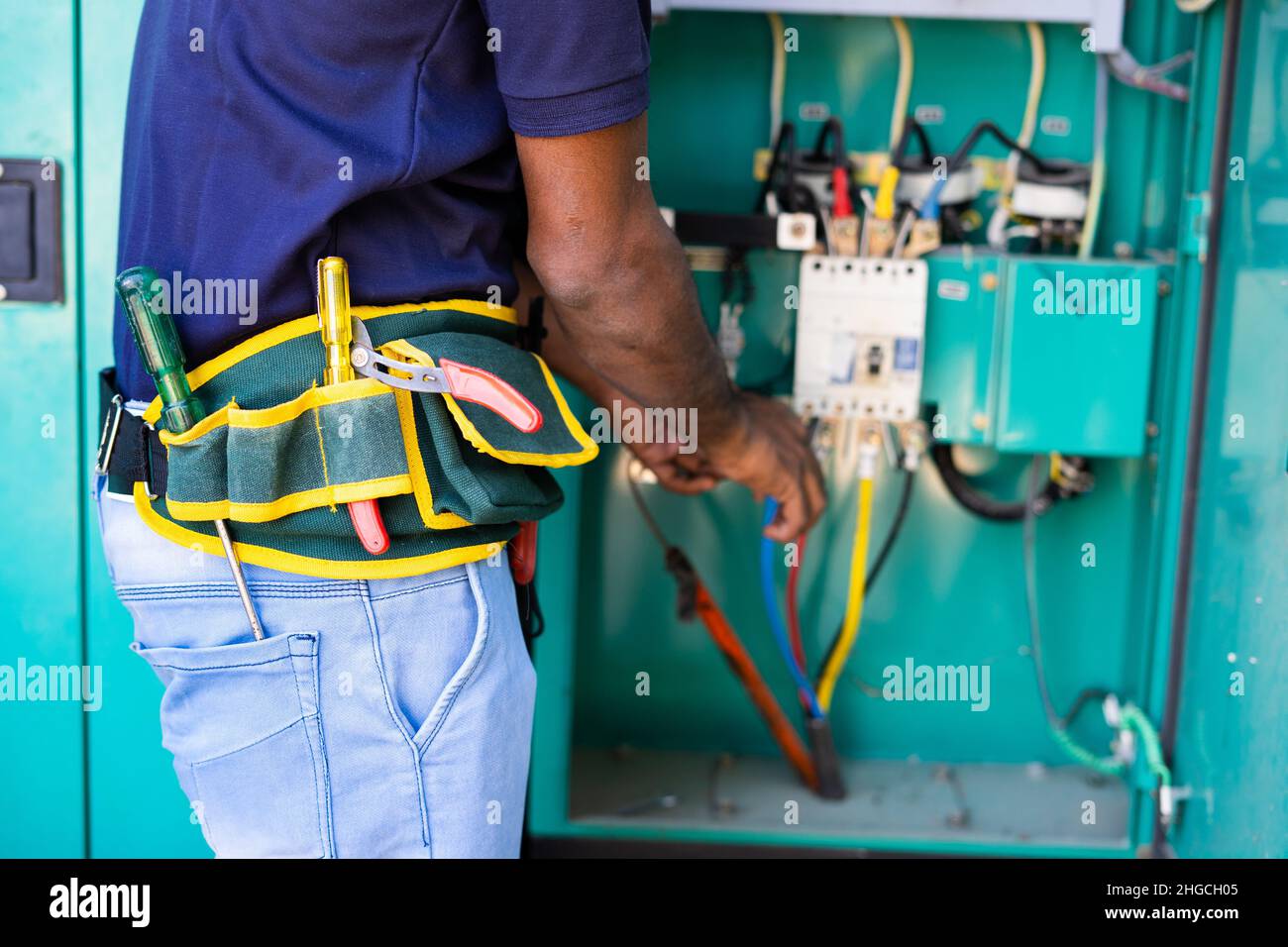 Close up shot of unrecongnizable electrician working by using tools or equipments for maintenance or repair service - concept of checking connections Stock Photo