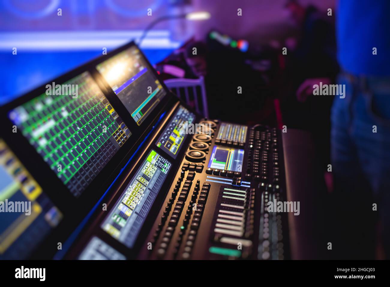 View of lighting technician operator working on mixing console