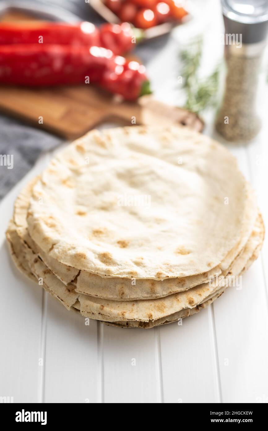 Arabic bread. Flat pita bread on white table. Stock Photo