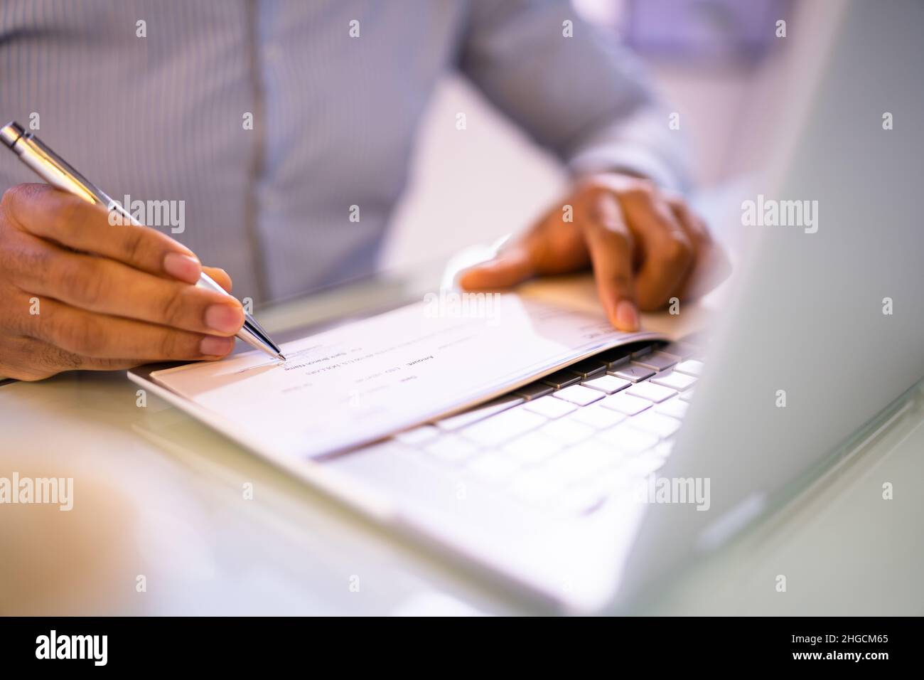 View of Writing Payroll Compensation Check. Bank Pay Cheque Stock Photo - Alamy