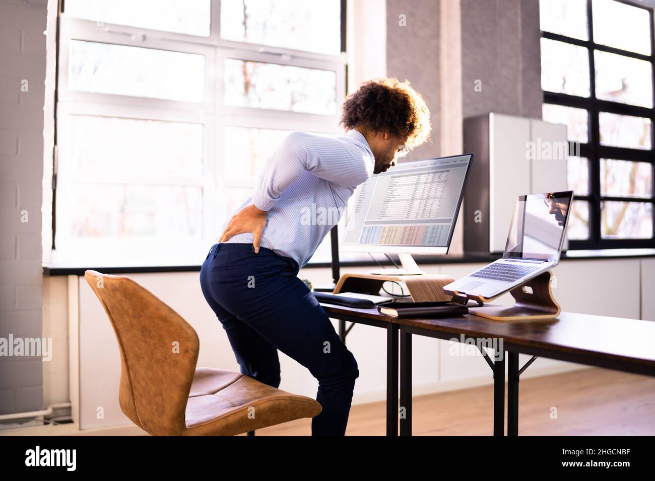 Back Pain Bad Posture Man Sitting In Office Stock Photo Alamy