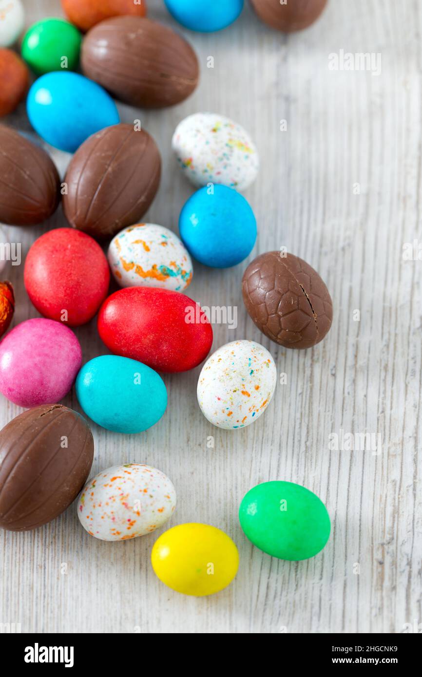 Easter candy eggs on white wooden surface Stock Photo