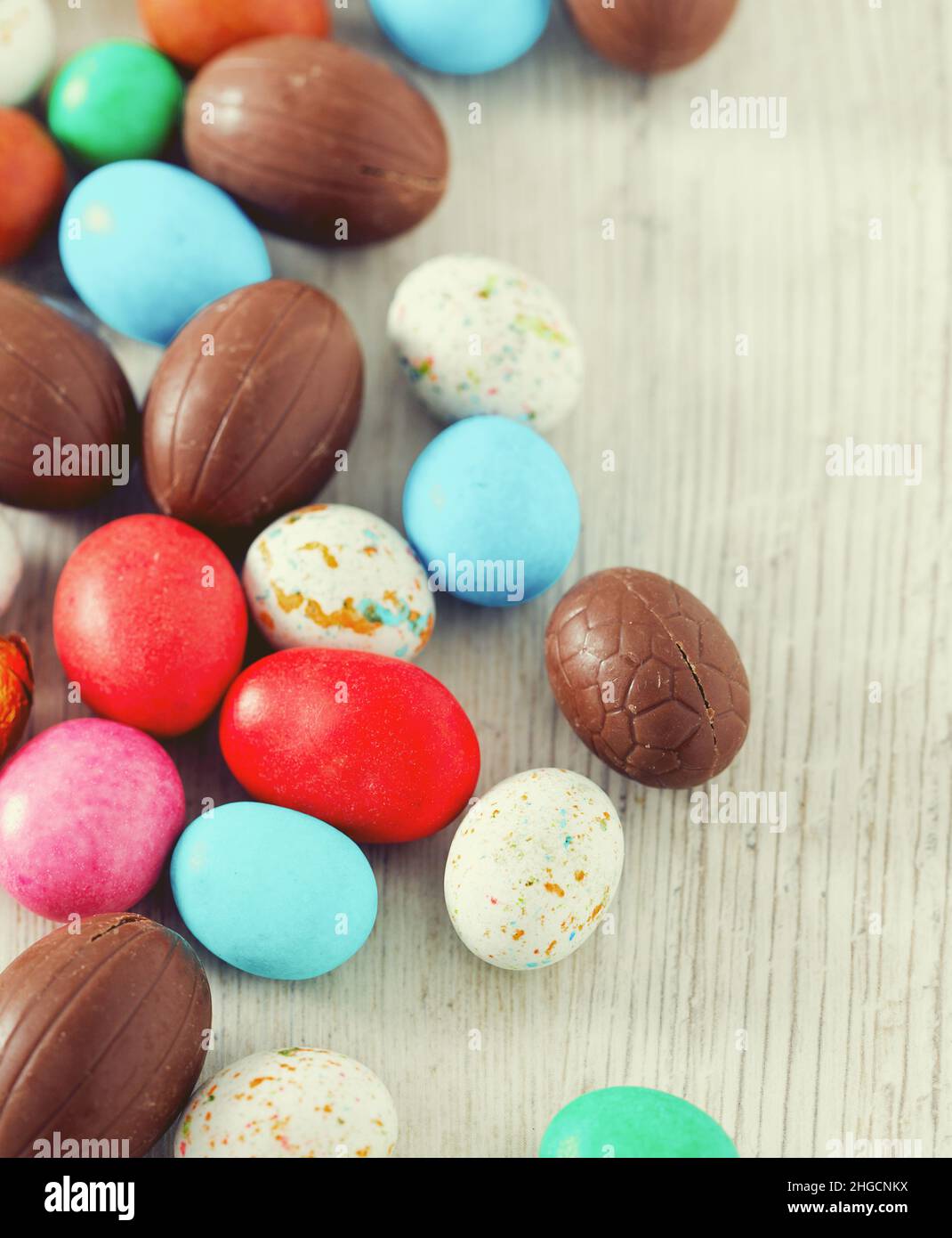 Easter candy eggs on white wooden surface Stock Photo