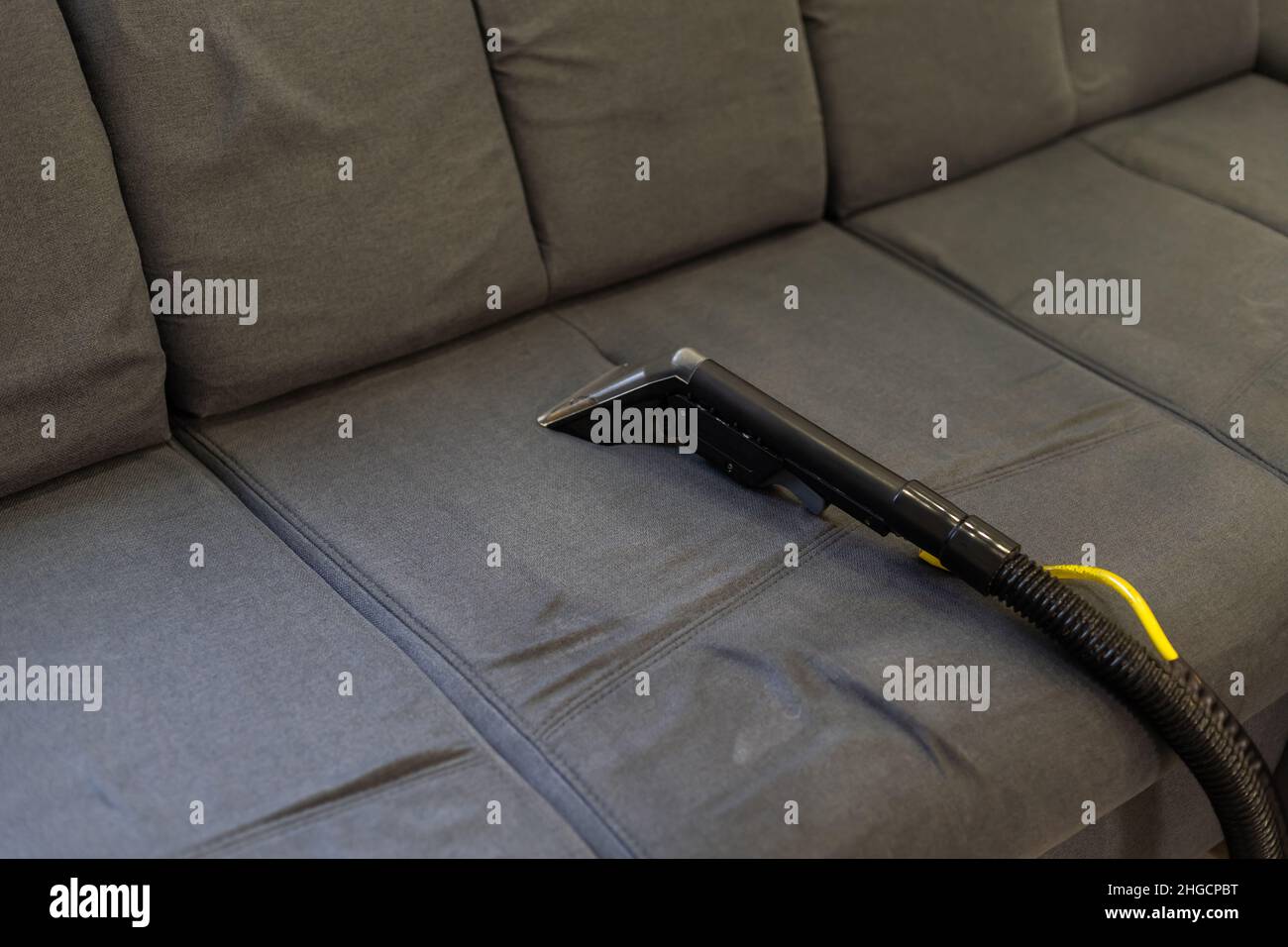Cleaning Sofa With Vacuum Cleaner Stock Photo Alamy