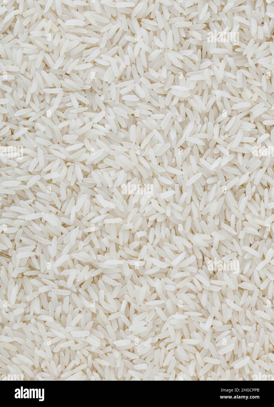 Uncooked white longgrain rice background Stock Photo Alamy