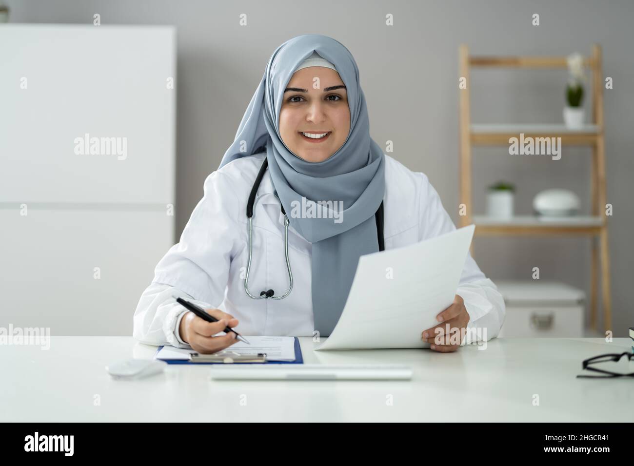 Muslim Woman Physician Doctor Video Conference Call Stock Photo