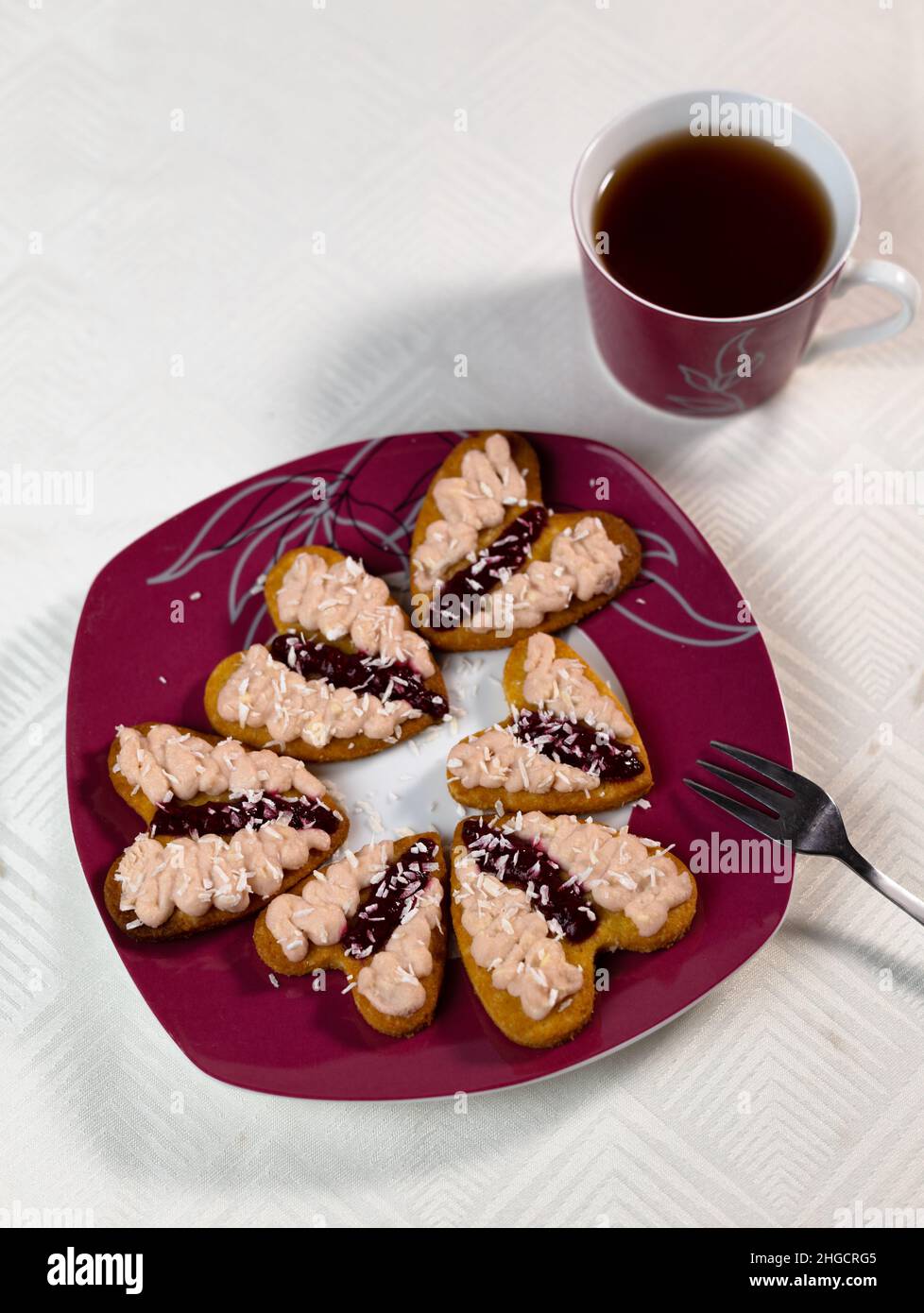 Traditional australian dessert iced vovo. Biscuit cookies with fudge and raspberries jam