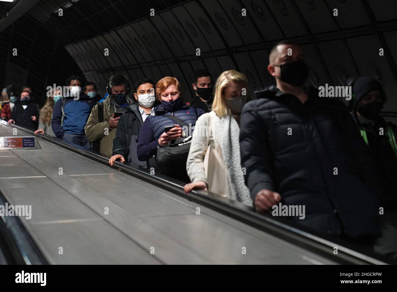 Commuters at Waterloo underground station in London make their way into offices after advice to work from home was dropped on Wednesday by Prime Minister Boris Johnson. Picture date: Thursday January 20, 2022. Stock Photo