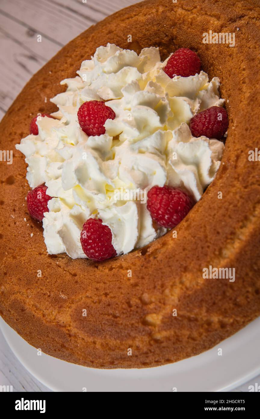 Pastry, Traditional Italian rum cake with whipped cream and raspberries