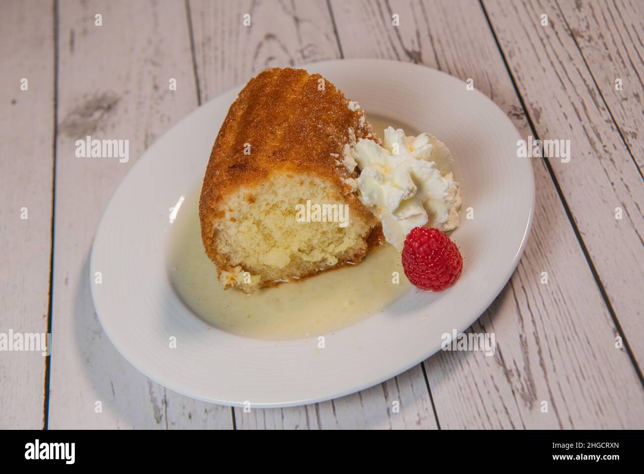 Pastry, Traditional Italian rum cake with whipped cream and raspberries