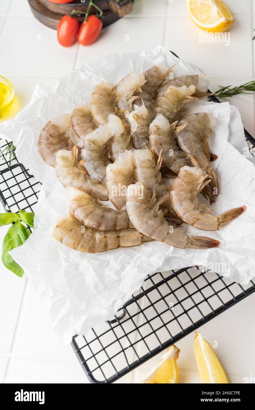 Thawed peeled shrimp, seafood, delicacy. on a white background, in a ...