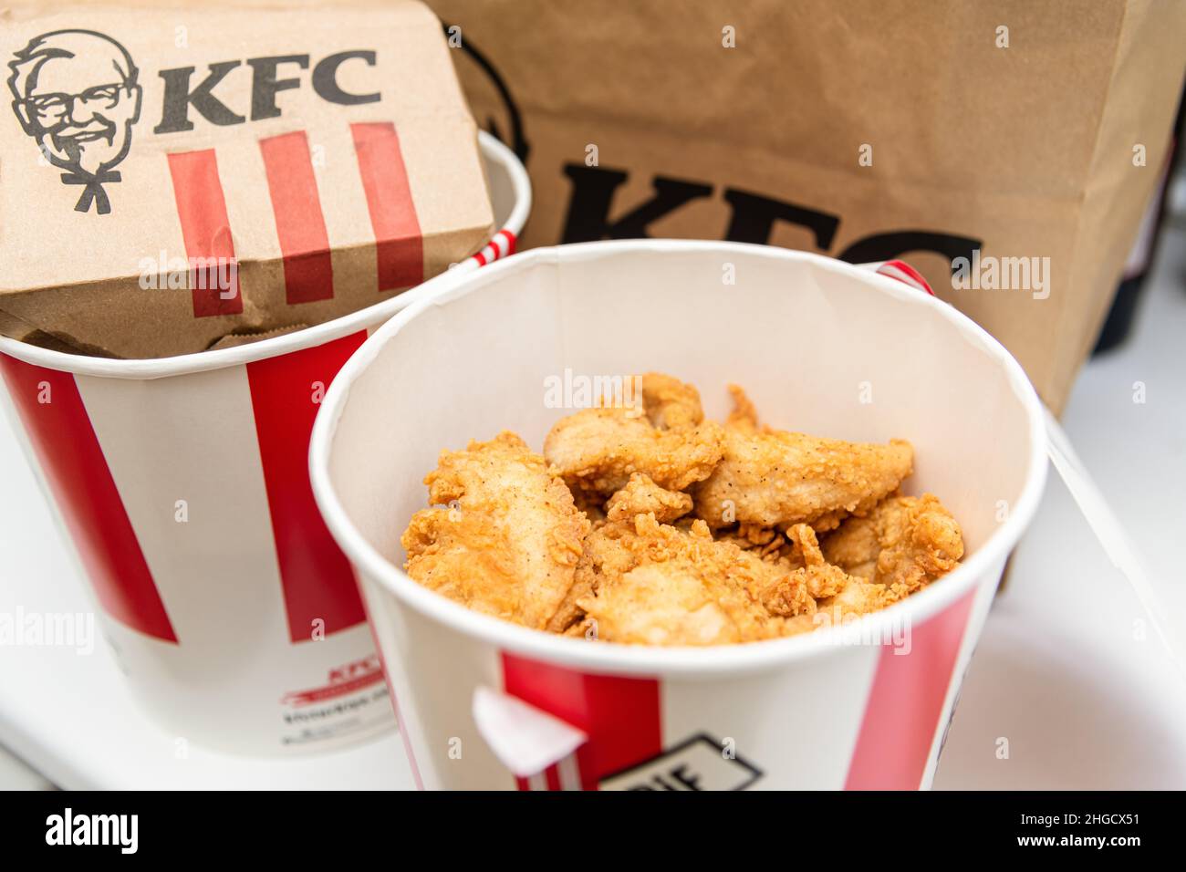 Antalya, Turkey - January 20, 2022: A lots of KFC chicken hot strips or nuggets in bucket of KFC ( Kentucky Fried Chicken ) fast food. Stock Photo